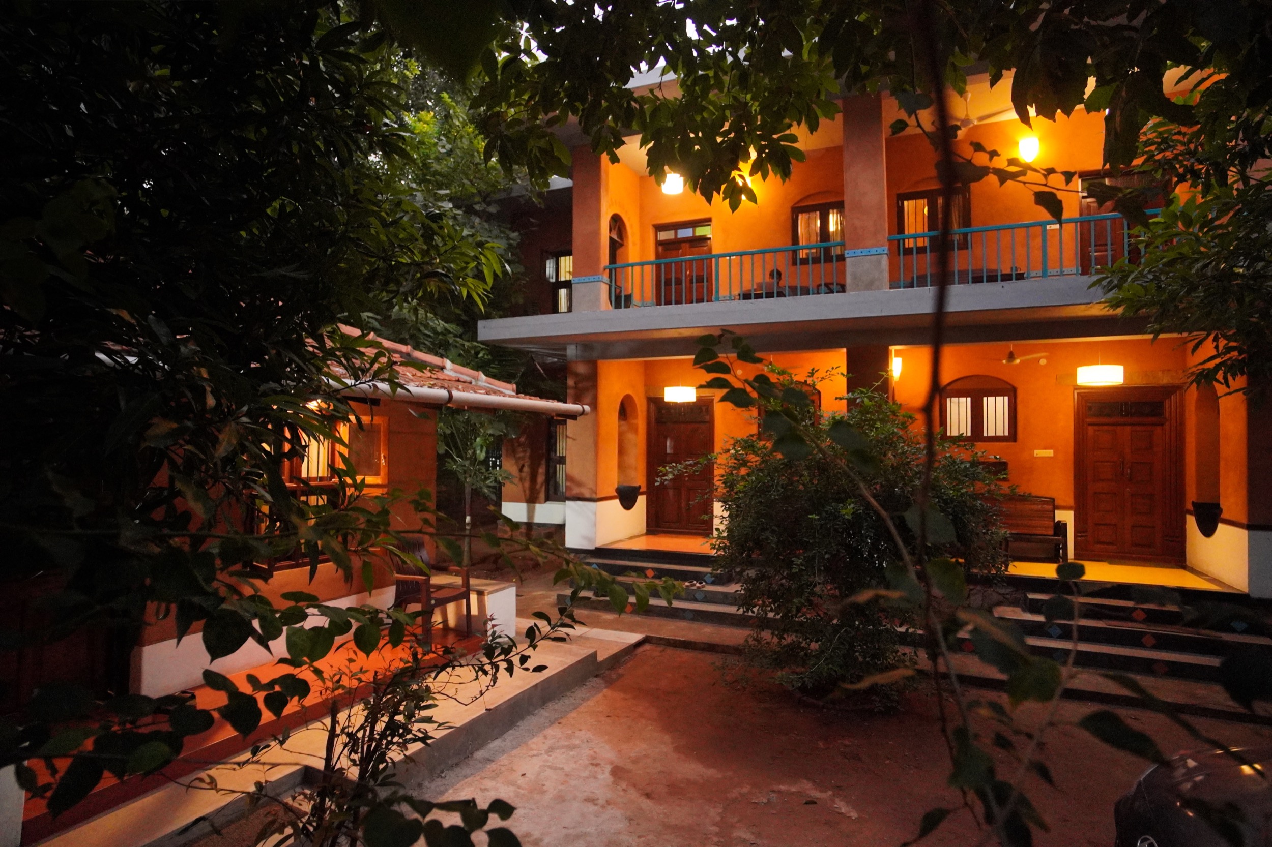 Anpu cob retreat complex at night — peaceful eco accommodation near Auroville and Pondicherry