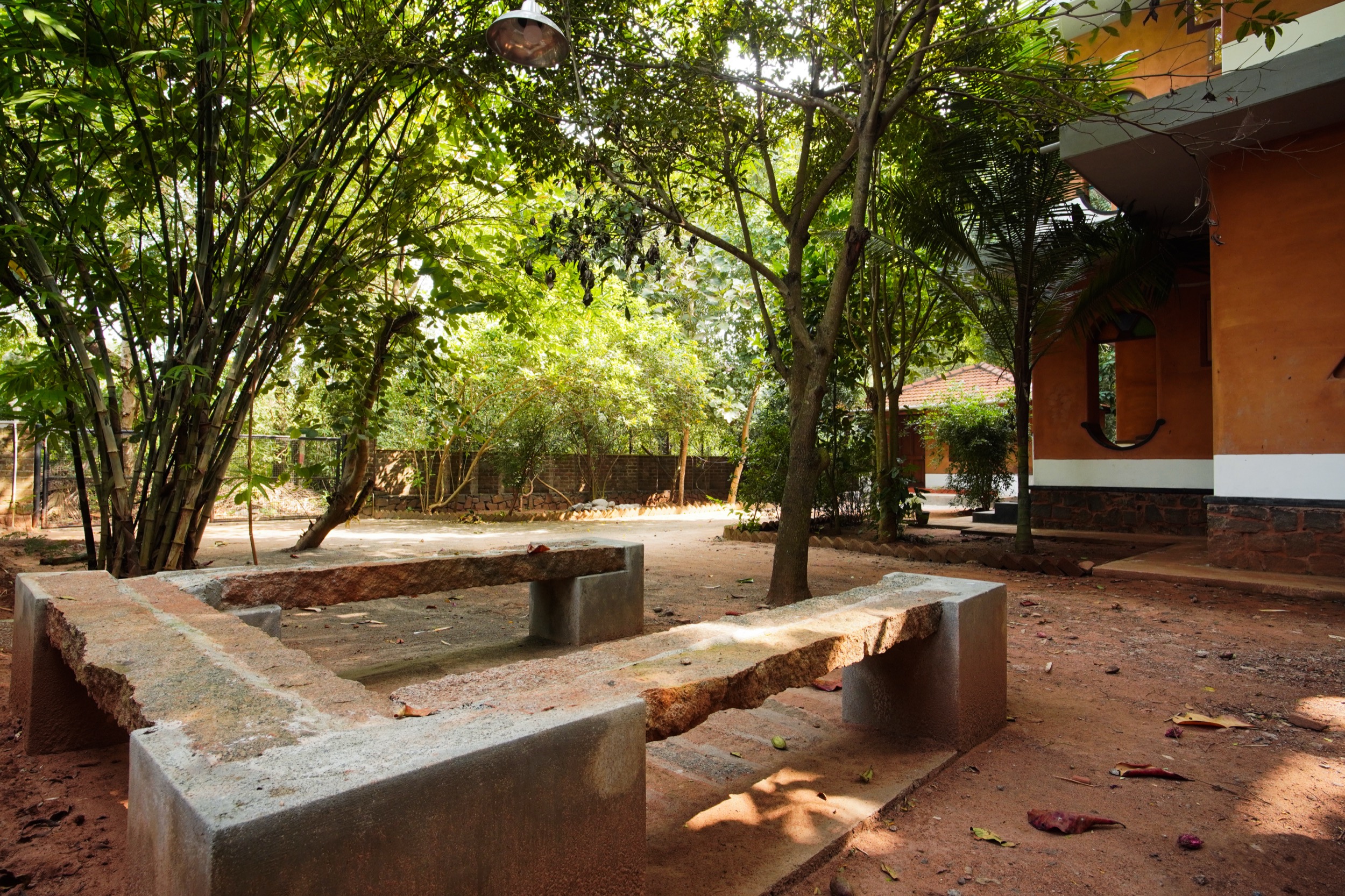 Outdoor garden seating area at Anpu cob retreat, Auroville bioregion, Tamil Nadu