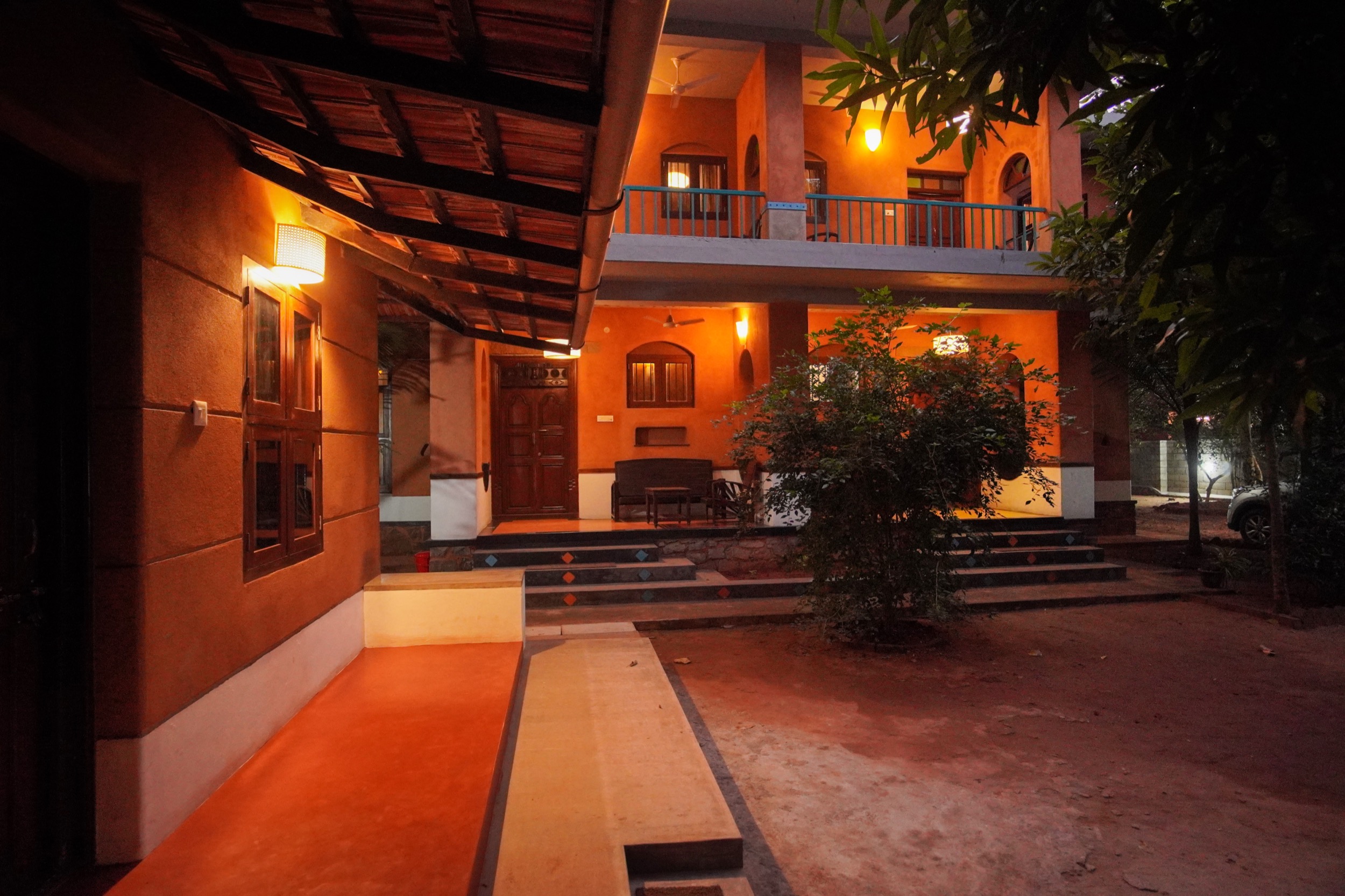 Anpu cob retreat main building illuminated at night, Edayanchavadi near Auroville